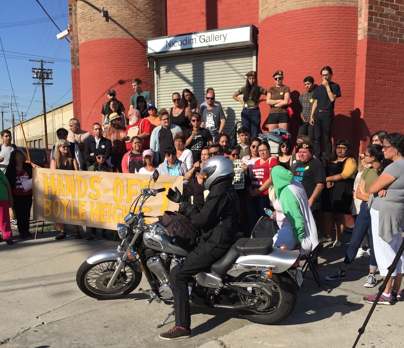 A gallery worker arrived on her motorcycle during the press conference.