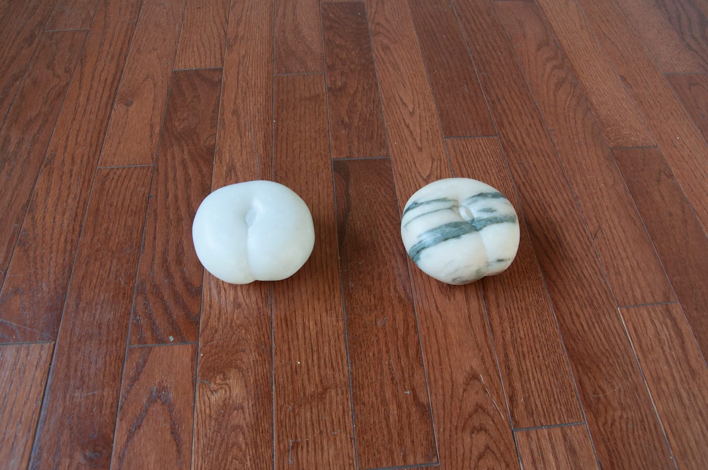 Catalina Ouyang, "Peaches of Immortality of the Queen Mother of the West on Pedestal I" (2016, left), hand-carved Portuguese marble, beeswax, polyester, dye; "Peaches of Immortality of the Queen Mother of the West on Pedestal II" (2016, right), hand-carved Portuguese marble, beeswax, polyester, dye