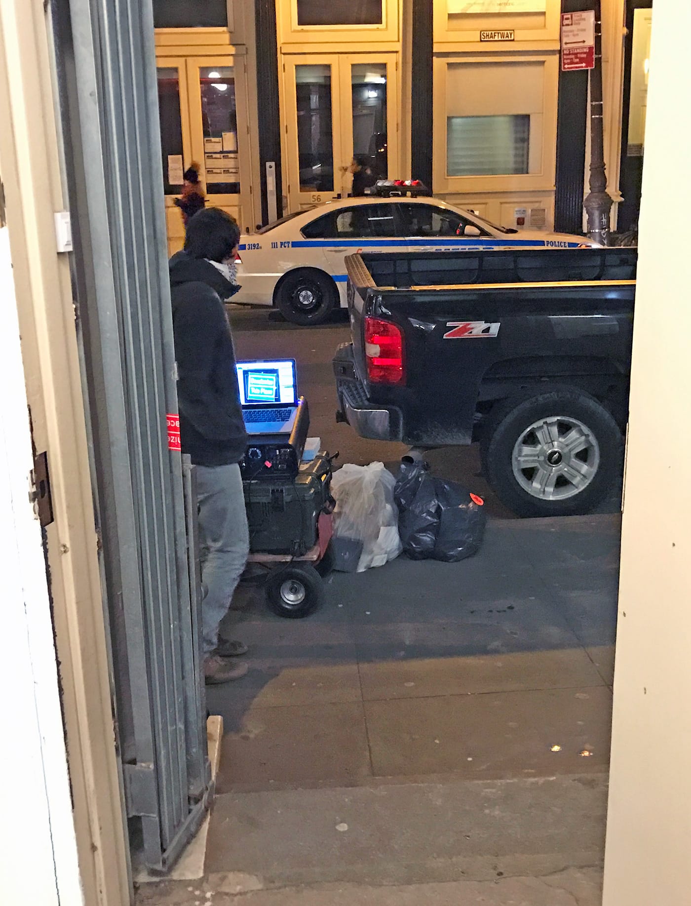 One of the many police vehicles on the block of Artists Space. This one is framed by the front door of Artists Space at 55 Walker Street, Manhattan.