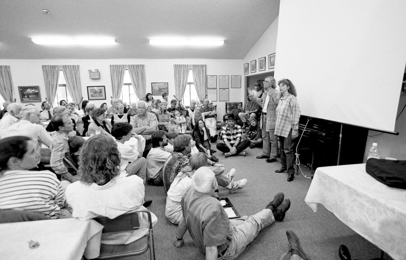At a public meeting, Christo and Jeanne-Claude introduce the "Over The River" project to the local community and answer questions from the audience on April 18, 1997 (photo by Wolfgang Volz, © 1997 Christo)