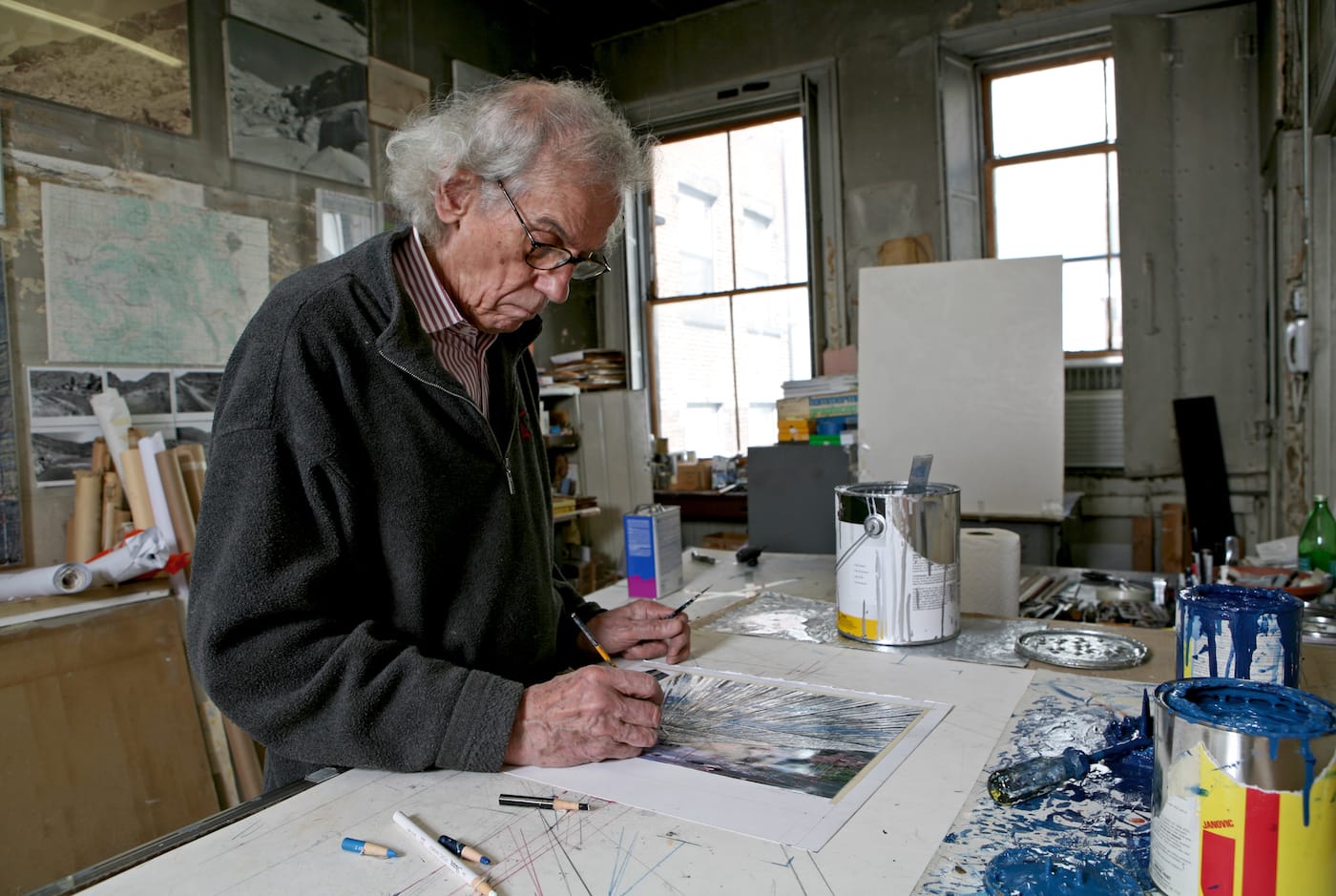 Christo in his studio working on a preparatory collage for "Over The River" in 2011 (photo by Wolfgang Volz, © 2011 Christo)