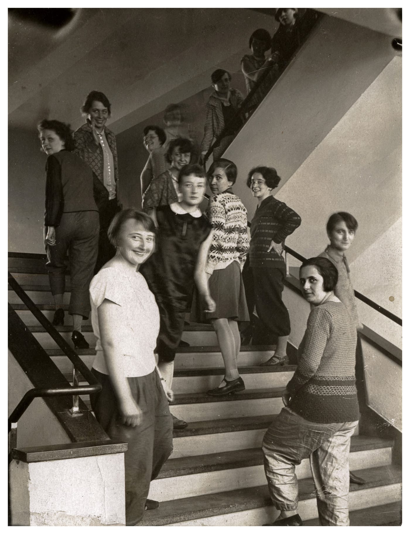 T. Lux Feininger, “The Weavers on the Bauhaus Stairway" (1927); from left, going up the stairs: Lena Bergner, Grete Reichardt; center top: Gunta Stölzl; next to her: Lijuba Monastirsky; coming down: Otti Berger, Lis Beyer; on her right: Elisabeth Mueller, Rosa Berger; Ruth Hollos behind Lisbeth Oestreicher in front (© Bauhaus Archiv Berlin)