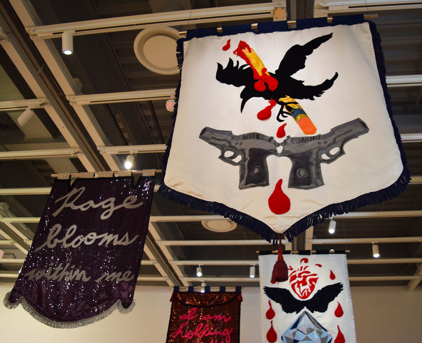 Cauleen Smith, "In the Wake" (2017), satin, poly-satin, quilted pleather, upholstery, wool felt, wool velvet, indigo-dyed silk-rayon velvet, indigo-dyed silk satin, embroidery floss, metallic thread, acrylic fabric paint, acrylic hair beads, acrylic barrettes, satin cord, polyester fringe, poly-silk tassels, plastic-coated paper, and sequins (photo by Benjamin Sutton for Hyperallergic)