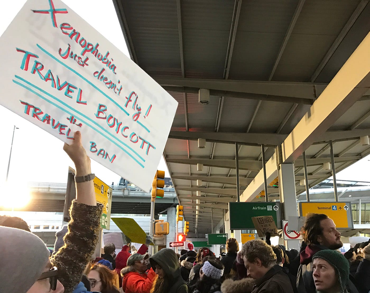 Protesters at New York's JFK Airport following the passage of President Trump's first travel ban (photo by Jillian Steinhauer/Hyperallergic)