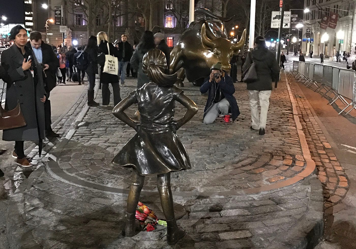 The "Fearless Girl" statue faces Arturo Di Modica's "Charging Bull" in Manhattan's Financial District. (photo by Jillian Steinhauer for Hyperallergic)