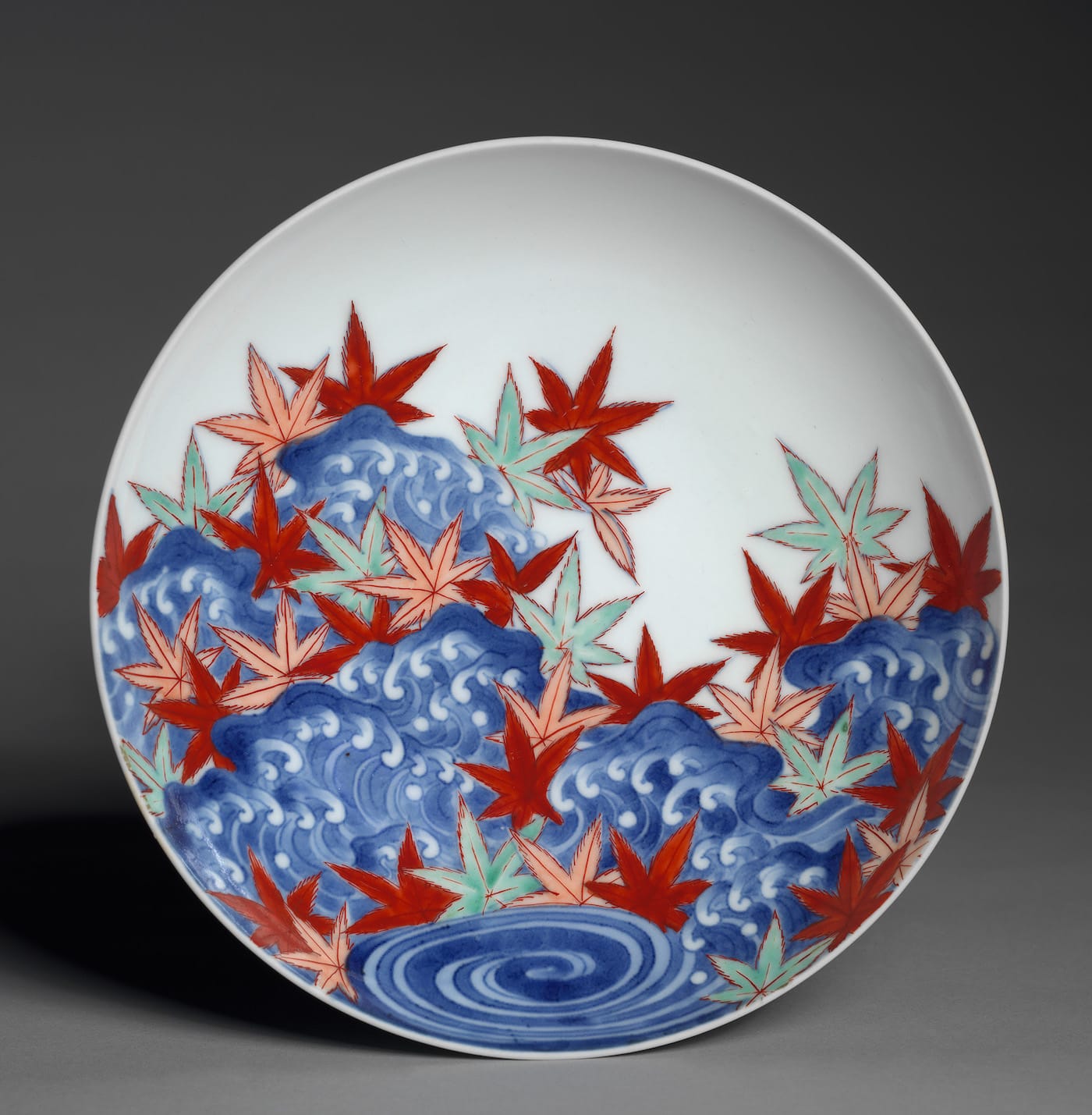 Dish with Maple Leaves in Waves, Japanese, Edo period (1615–1868), Genroku/Shōtoku eras (1688−1716), porcelain with underglaze blue and overglaze color enamel (Hizen ware, Nabeshima type); diameter 7 3/4 in (courtesy the Cleveland Museum of Art)
