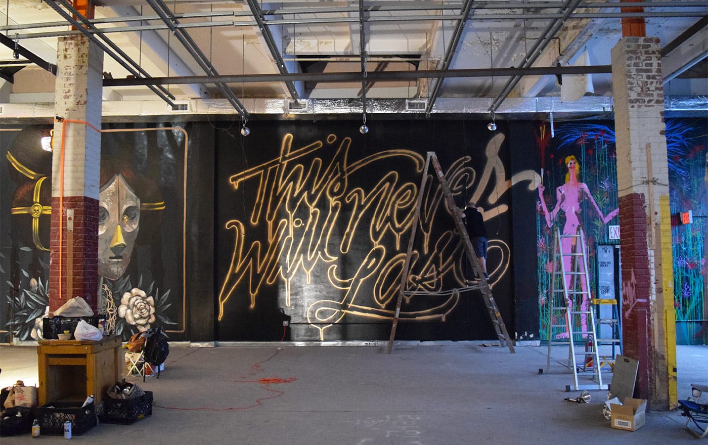 Mural by Faust in progress at <em>Market Surplus</em> (all photos by the author for Hyperallergic)