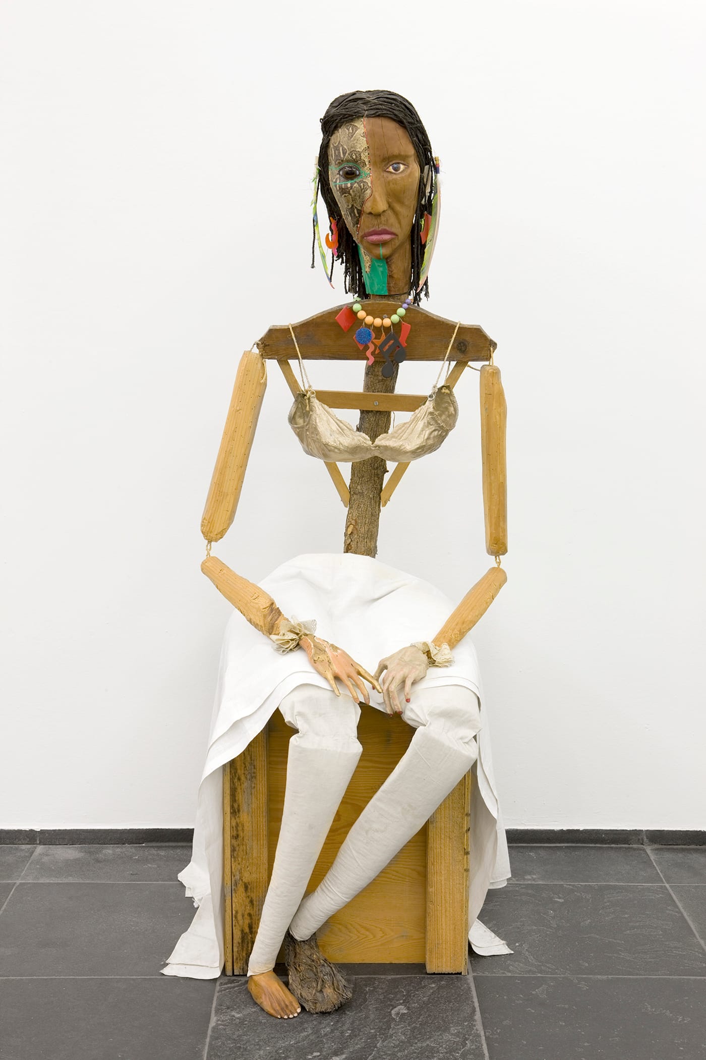 Jimmie Durham, "Malinche" (1988–92), guava, pine branches, oak, snakeskin, polyester bra soaked in acrylic resin and painted gold, watercolor, cactus leaf, canvas, cotton cloth, metal, rope, feathers, plastic jewelry, glass eye, 70 x 23 5/8 x 35 in, Stedelijk Museum voor Actuele Kunst (SMAK), Ghent, Belgium (photo © SMAK / Dirk Pauwels)