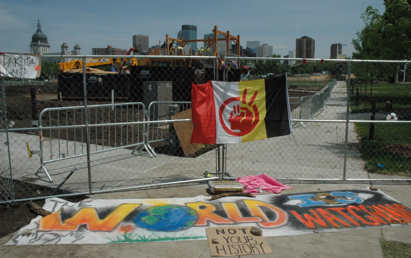 Signs near the site of Sam Durant's "Scaffold" (2012) as workers dismantled the sculpture on Friday (all photos by the author for Hyperallergic)