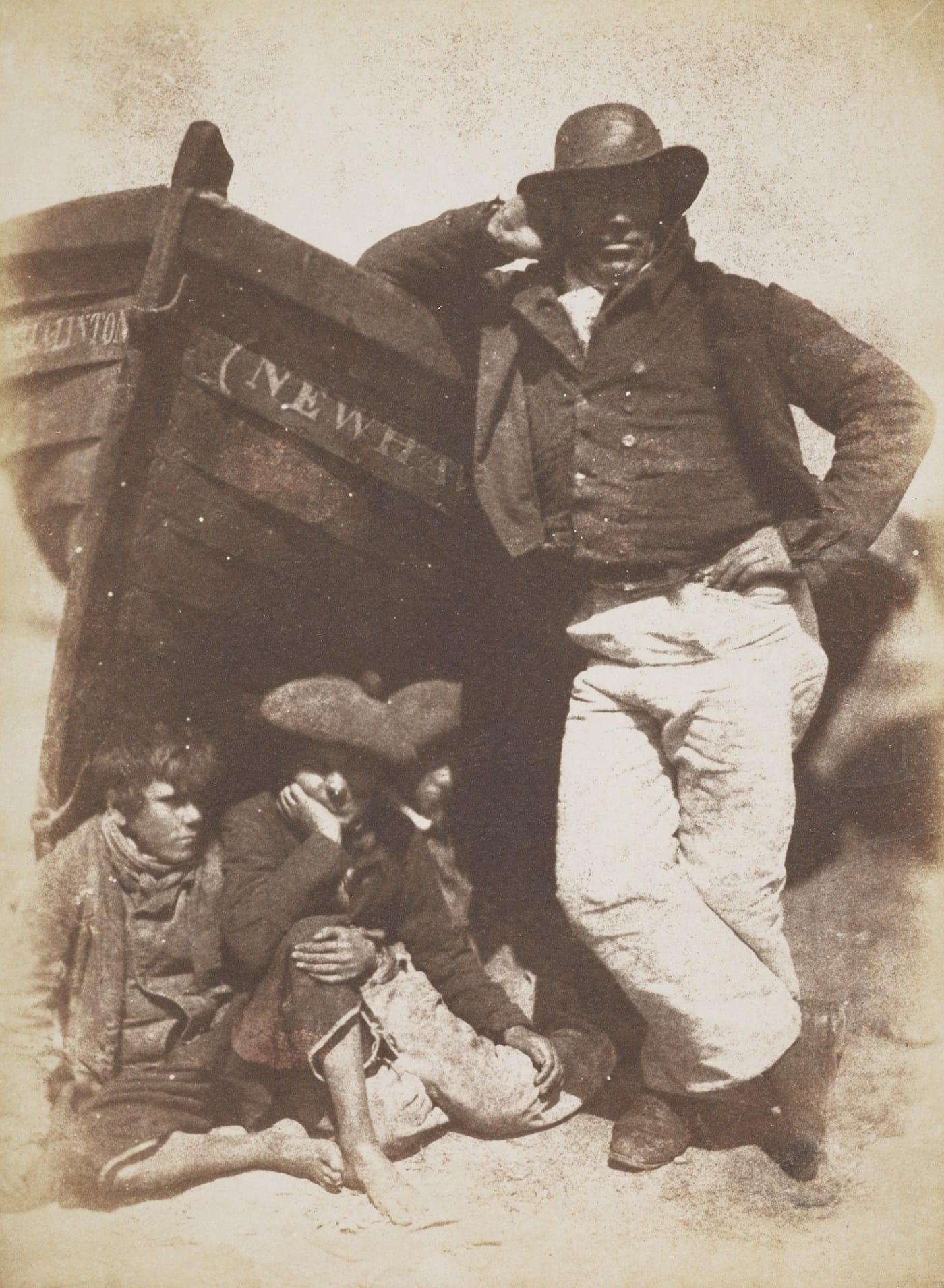 David Octavius Hill and Robert Adamson, "Sandy (or James) Linton, his boat and bairns" (June 1845), calotype print (courtesy Scottish National Portrait Gallery)