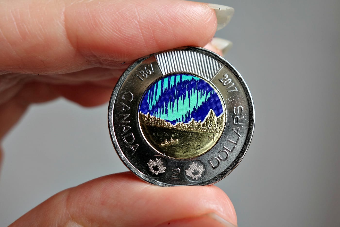 The "Dance of the Spirits" glow-in-the-dark coin from the Royal Canadian Mint (photo by the author for Hyperallergic)