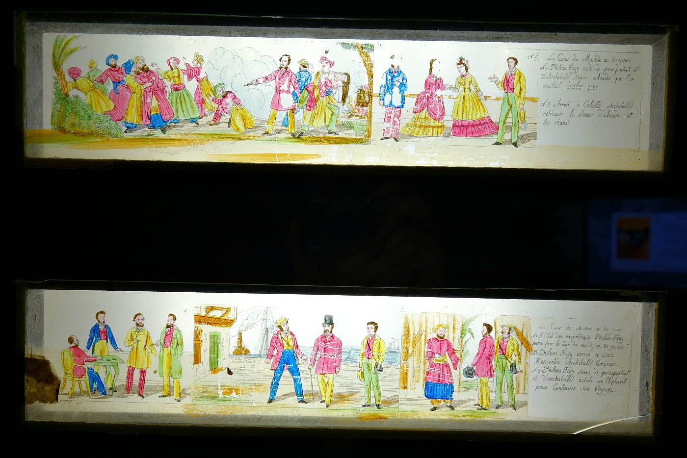 Glass plates for magic lantern depicting scenes from Jules Verne's <em>Around the World in Eighty Days</em> (Paris, 1885), lithographic transfer on glass (photo by the author for Hyperallergic)