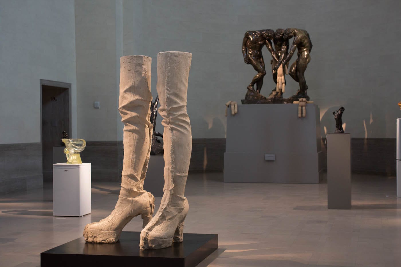 Installation view of <em/>Sarah Lucas: Good Muse with “Floppy Toilet,” “Jubilee,” and “Tit Teddy” by Sarah Lucas and “Three Shades” by Auguste Rodin (all photos by Katelynn Finnie for Hyperallergic)