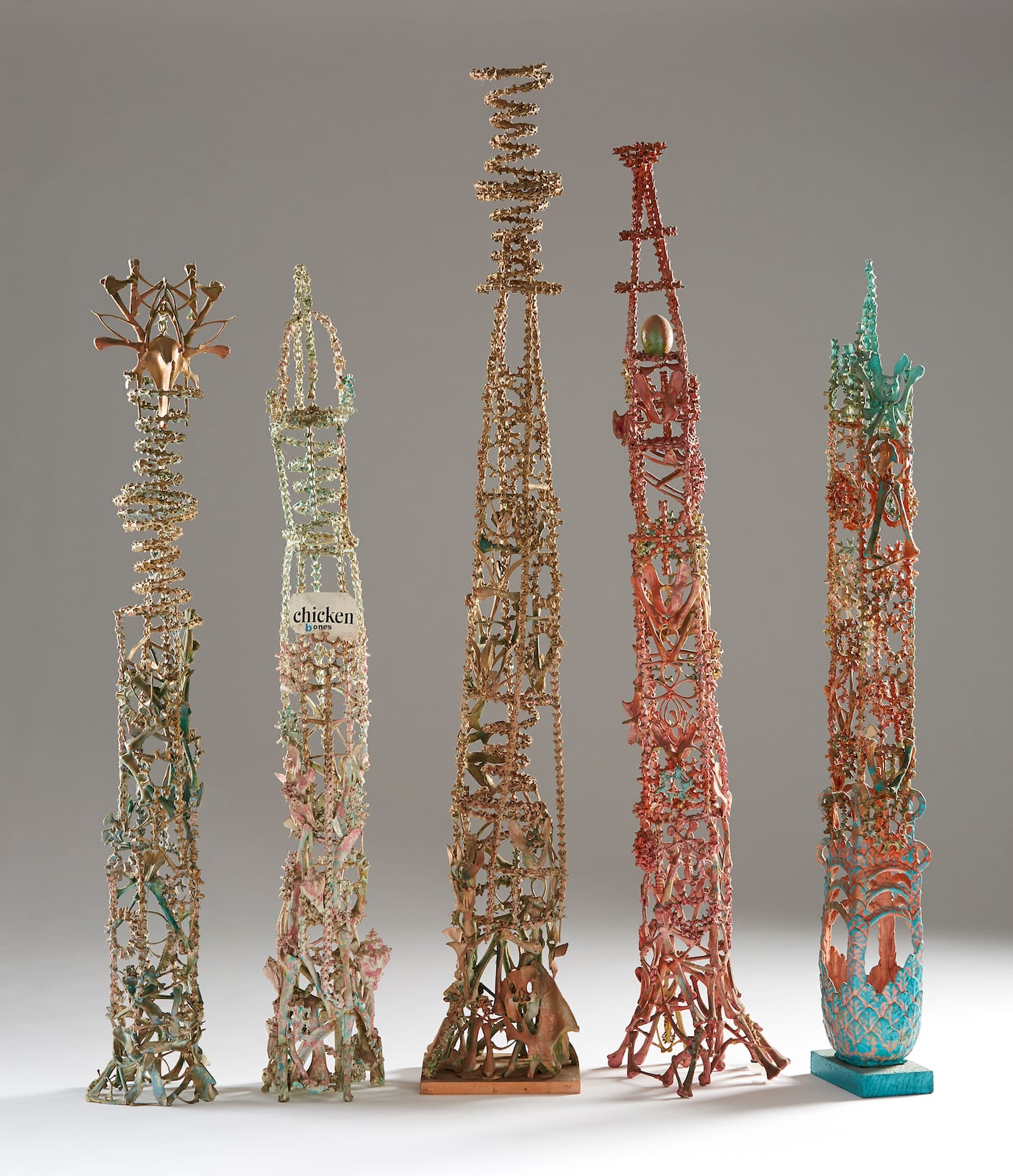 Eugene Von Bruenchenhein, "untitled (bone tower)" (1970–80), fowl bones, paint, glue, varnish, 44 x 8 x 6 5/8 inches; "Untitled (bone tower)" (1970–80), fowl bones, paint, glue, wire, seashells, 43 3/4 x 6 3/4 x 7 inches; "Untitled (bone tower)" (1970–80), fowl bones, paint, glue, 54 x 8 3/8 x 7 1/4 inches; "Untitled (bone tower)" (1970–80), fowl bones, paint, varnish, egg shells, 49 3/4 x 9 1/4 x 9 3/4 in. Untitled (bone tower), c. 1970–80; fowl bones, paint, glue, clay, wood; 44 x 6 3/4 x 5 1/2 inches (courtesy John Michael Kohler Arts Center Collection, photo by Rich Maciejewski)