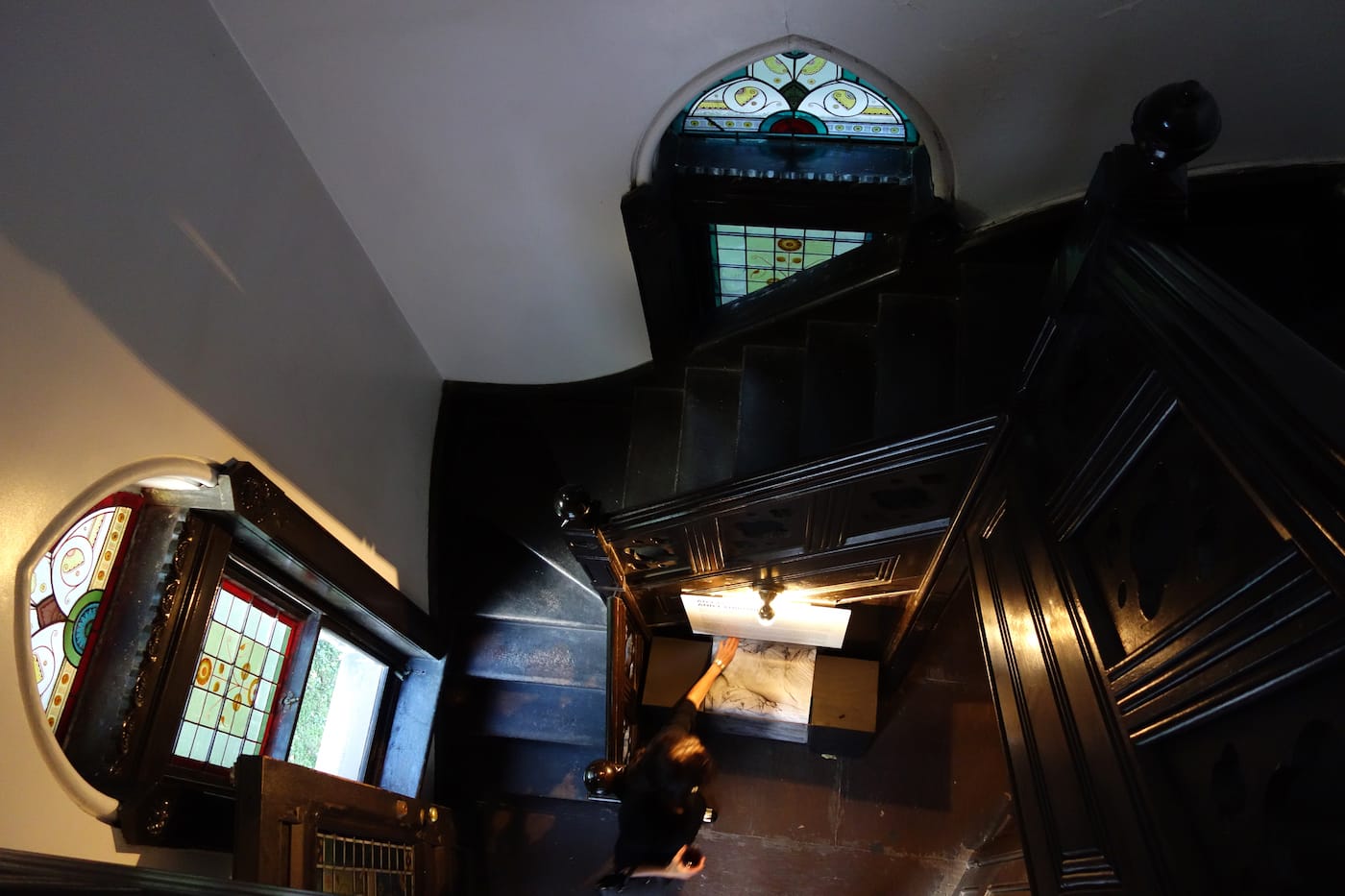 A visitor taking one of Matthew Jensen's maps in the Green-Wood Cemetery gatehouse (photo by the author for Hyperallergic)