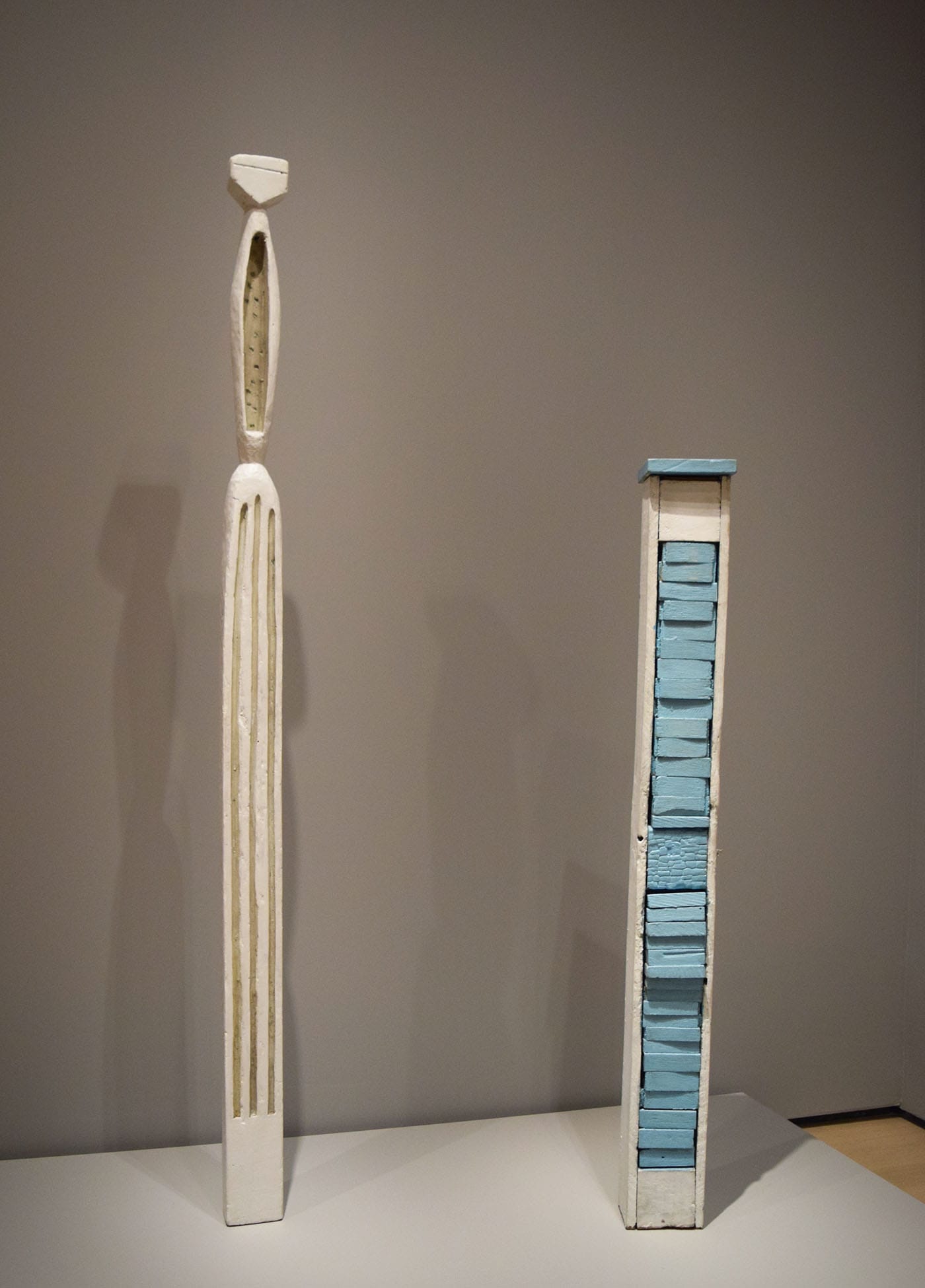 Louise Bourgeois, "Figure" (1954), painted wood, at right; and "Pillar" (1949–50), painted wood, at left
