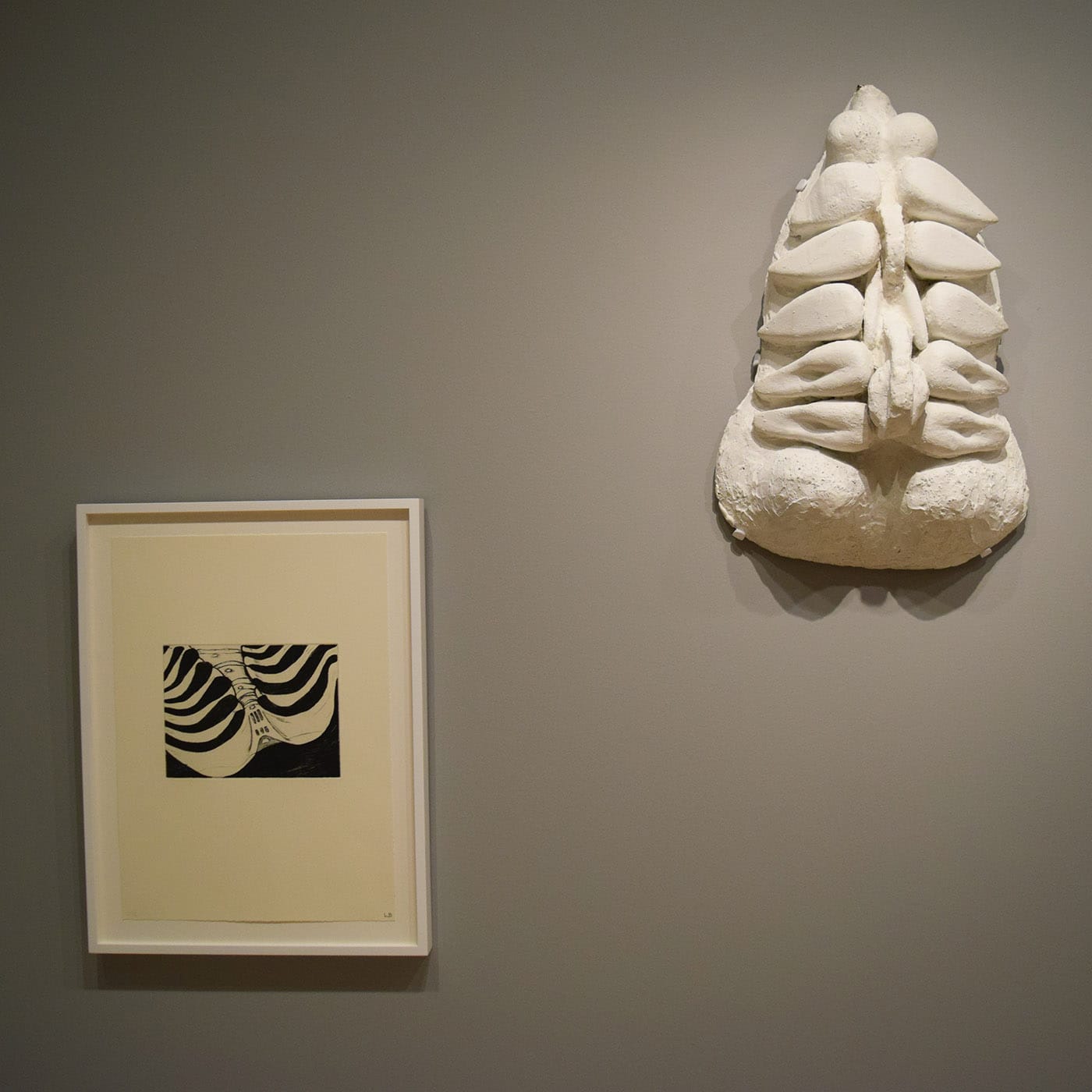 Louise Bourgeois "Untitled no. 5 of 12" from the portfolio Anatomy (1989–90), drypoint, at left; and "Torso, Self Portrait" (1963–64), plaster at right