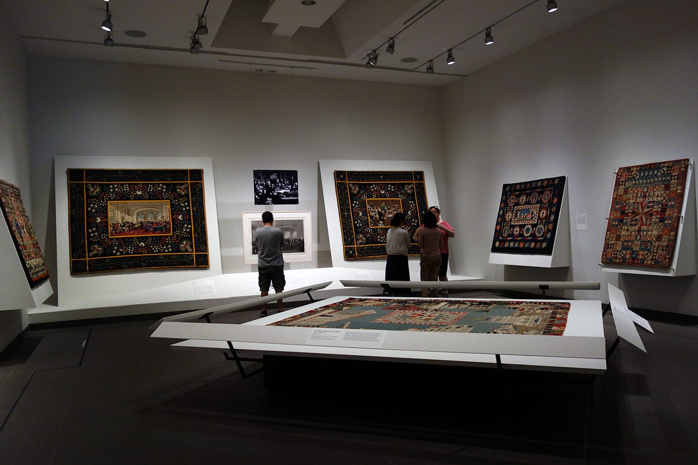 Installation view of <em>War and Pieced: The Annette Gero Collection of Quilts from Military Fabrics</em> at the American Folk Art Museum (photo by the author for Hyperallergic)