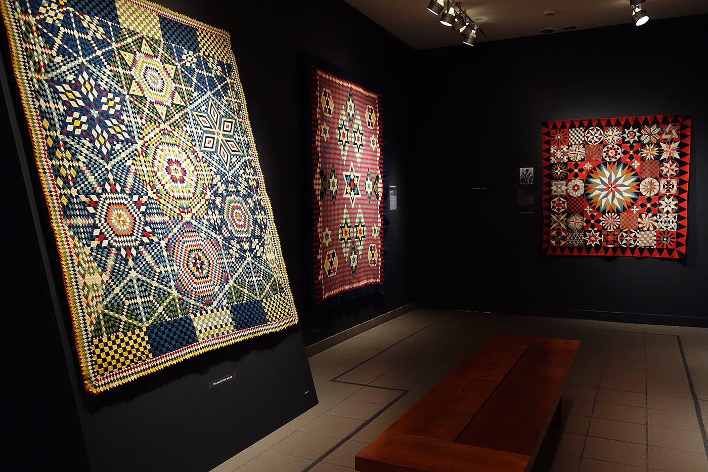 Installation view of <em>War and Pieced: The Annette Gero Collection of Quilts from Military Fabrics</em> at the American Folk Art Museum (photo by the author for Hyperallergic)