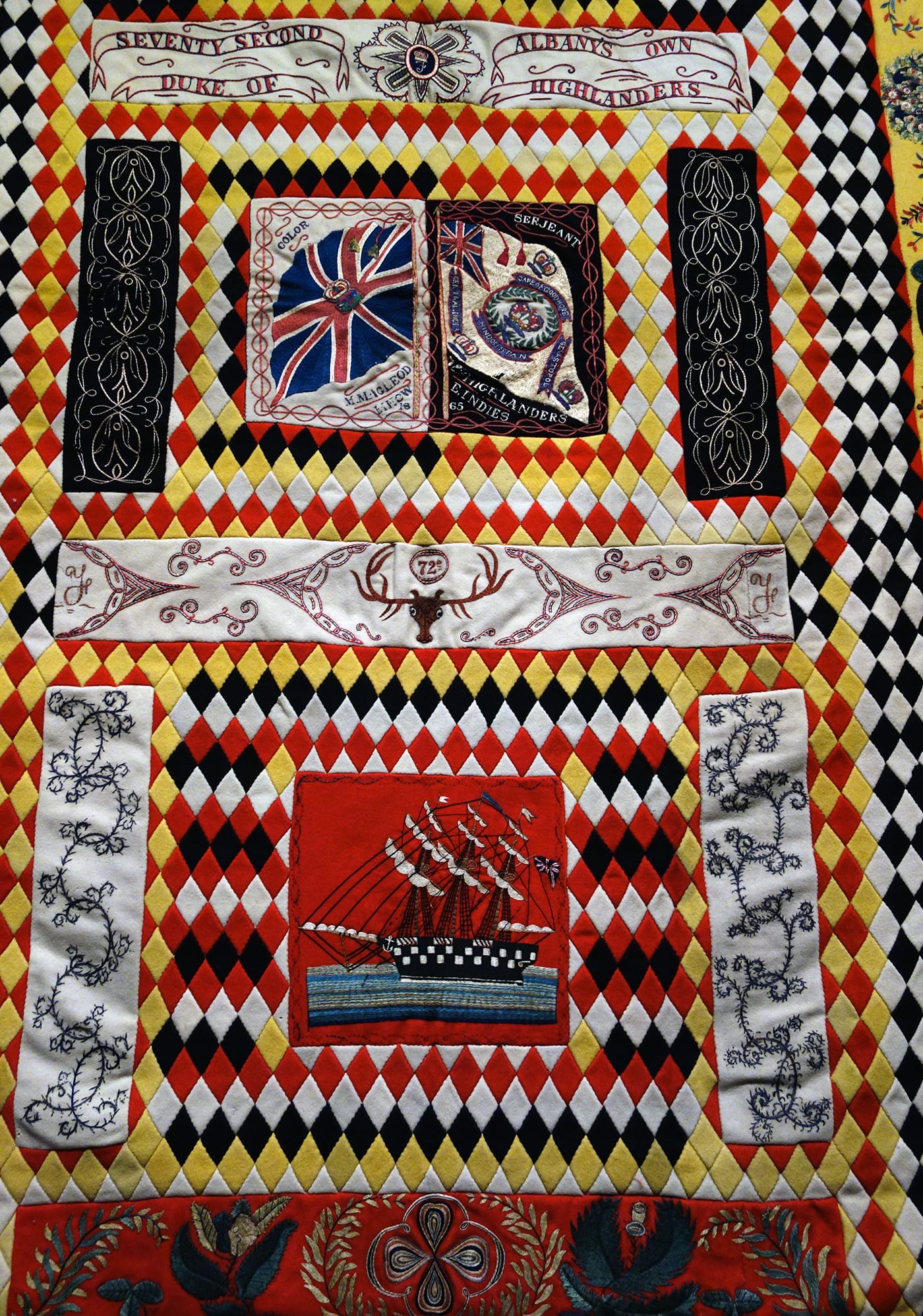 Installation view of <em>War and Pieced: The Annette Gero Collection of Quilts from Military Fabrics</em> at the American Folk Art Museum (photo by the author for Hyperallergic)