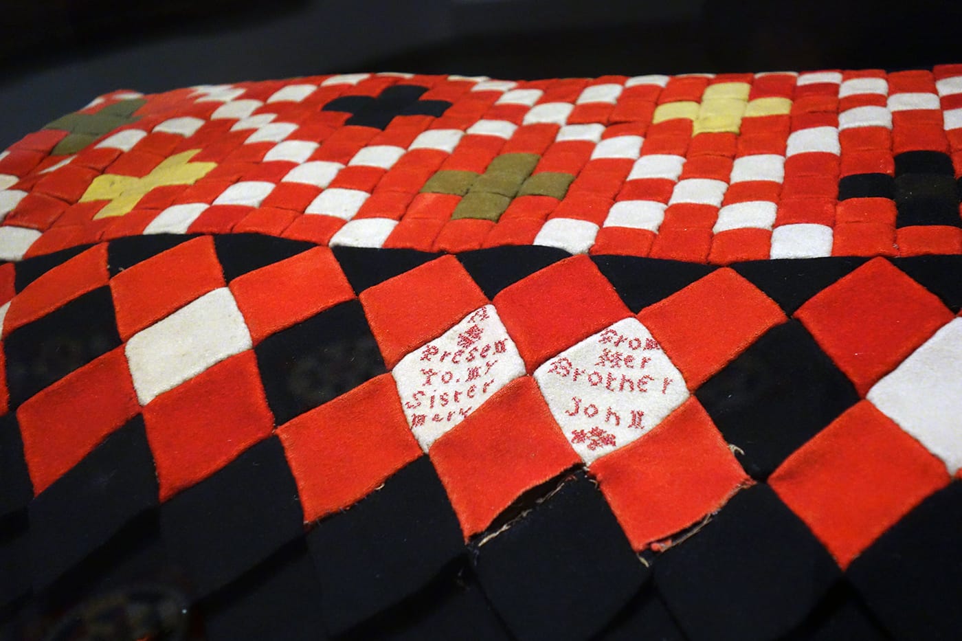 Installation view of <em>War and Pieced: The Annette Gero Collection of Quilts from Military Fabrics</em> at the American Folk Art Museum (photo by the author for Hyperallergic)