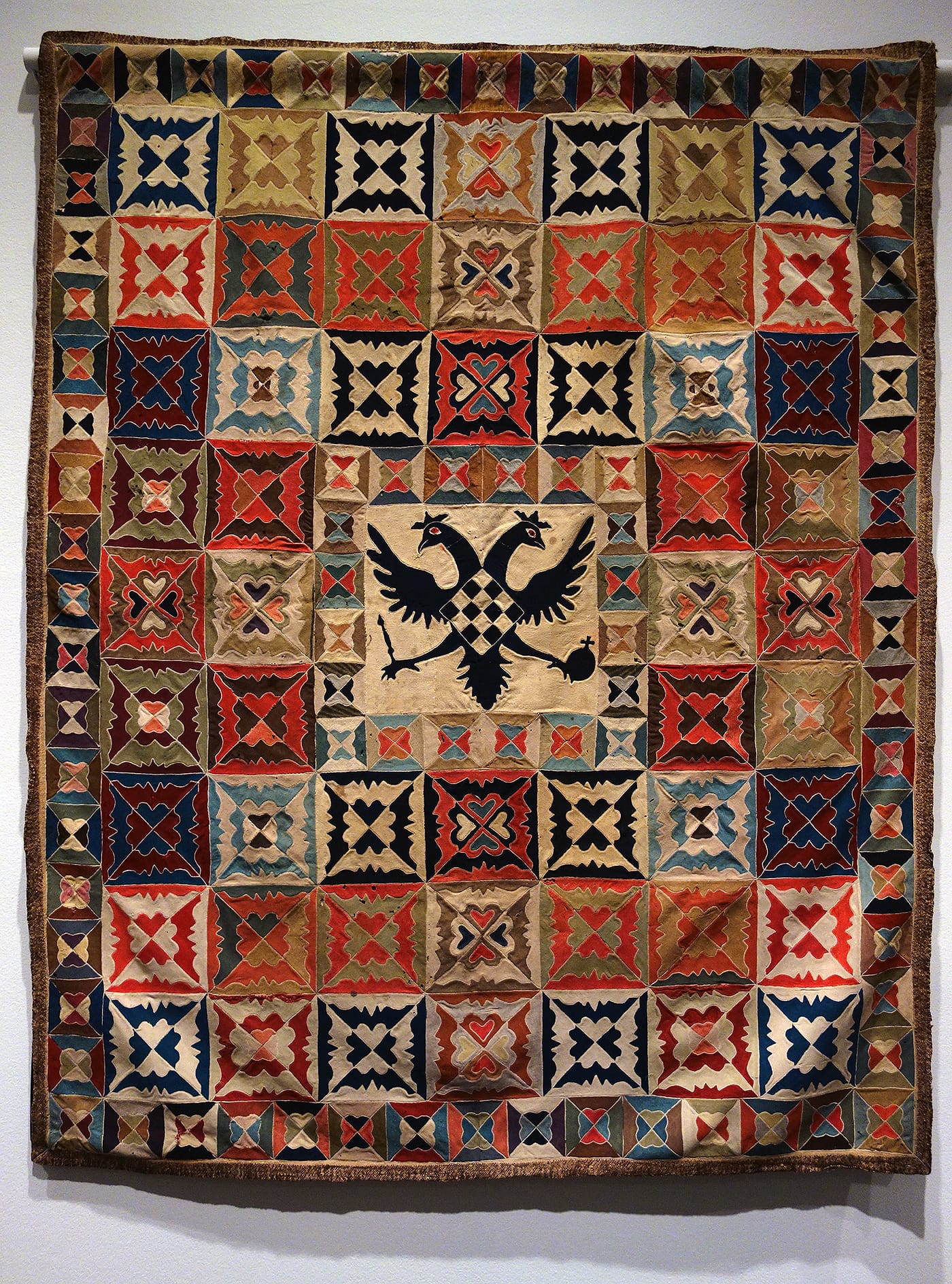 Army Uniform Quilt from the Napoleonic Era by an unidentified artist (Region unknown, possibly Prussia, late 18th/early 19th century), wool, probably from military uniforms; Silesian pieced (photo by the author for Hyperallergic)