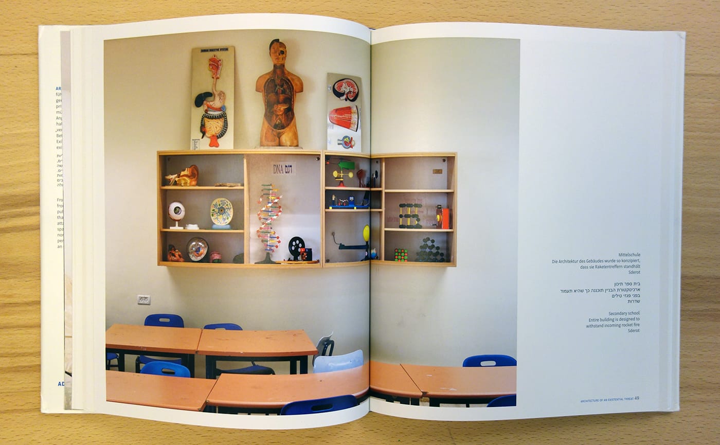 Pages from <em>Architecture of an Existential Threat</em> (photo of the book for Hyperallergic)