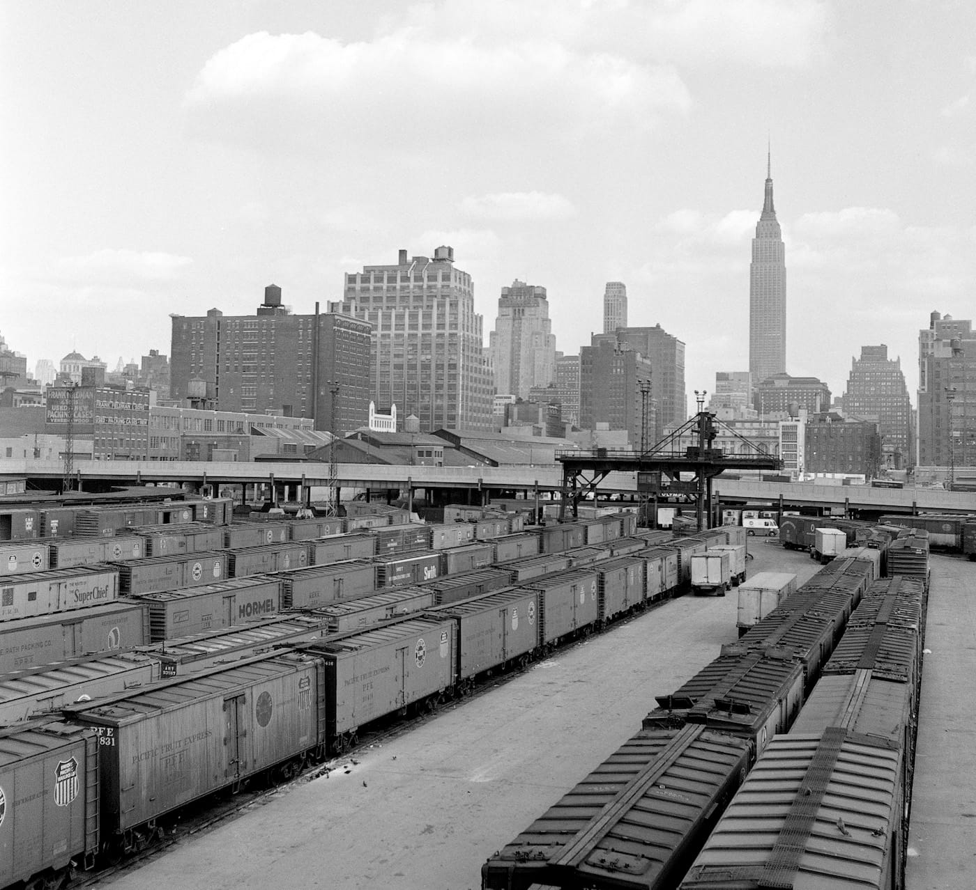 Jim Shaughnessy, "New York Central 30th Street freight yard with view of Empire State Building, New York City, New York" (1957) (courtesy the artist and Thames & Hudson)