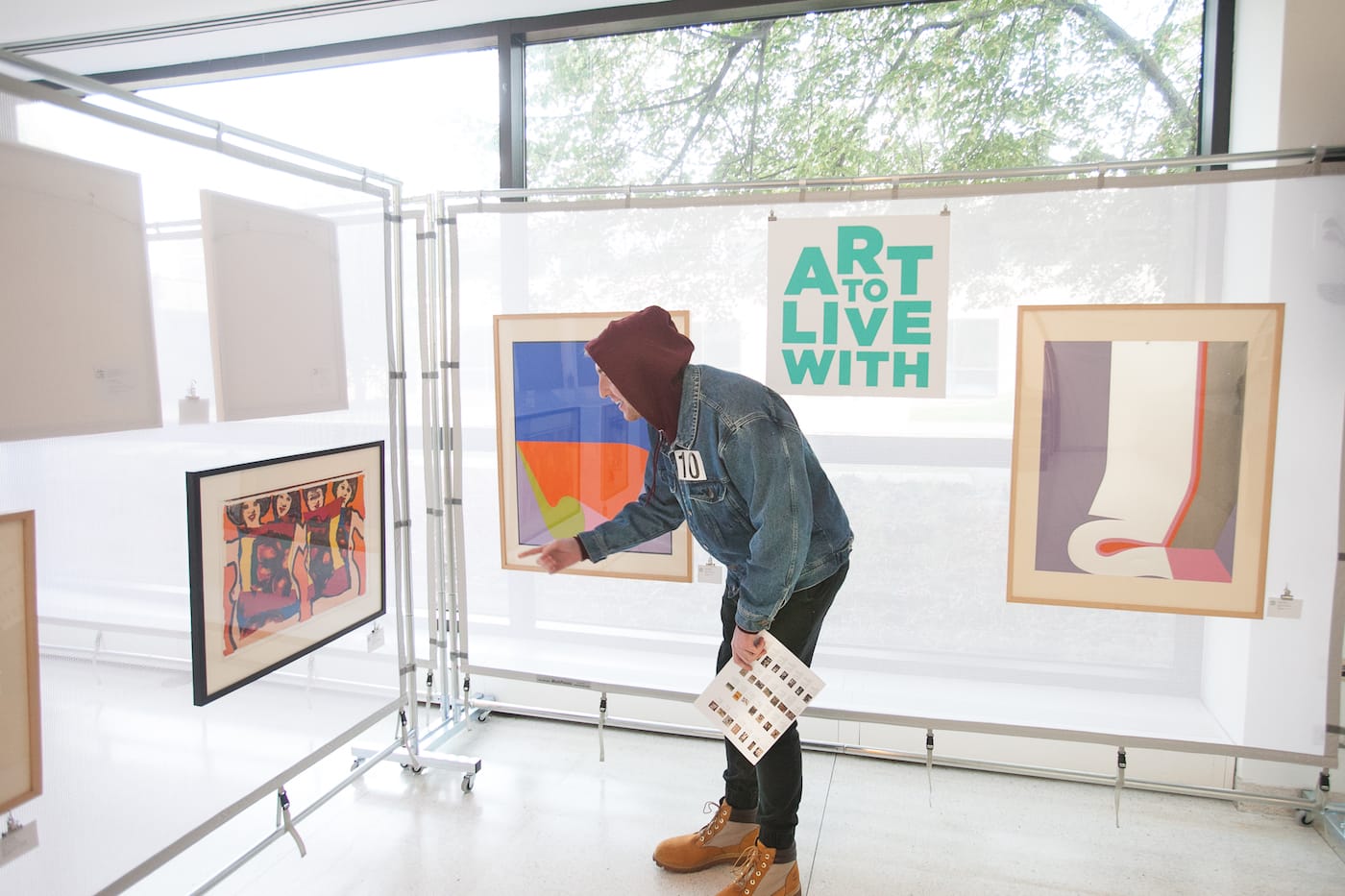 First year student Michael Burke chooses his piece of art at the Smart Museum during the Art To Live With art loan program on Sunday, October 1, 2017 (photo by Eddie Quinones, courtesy the University of Chicago)
