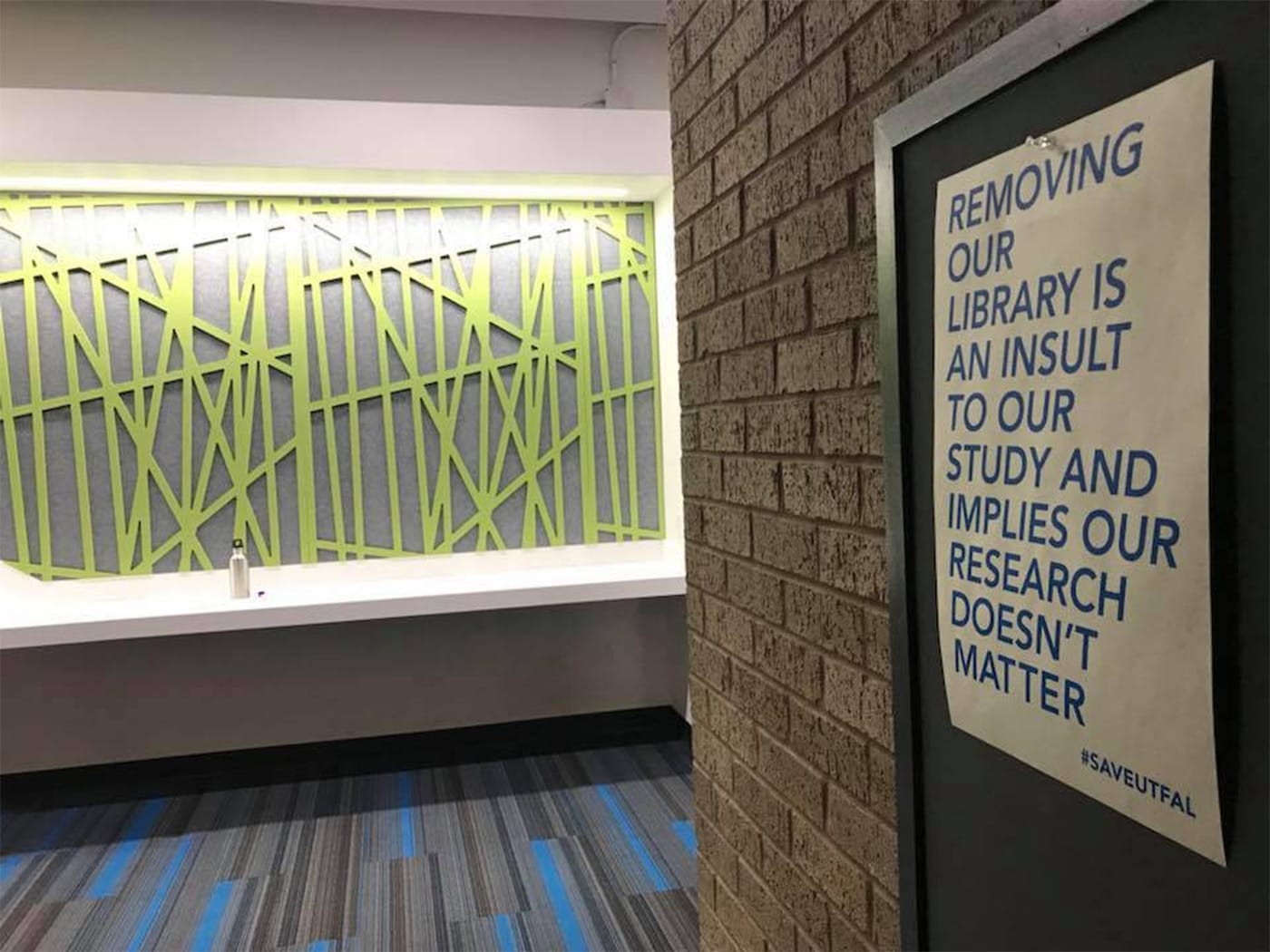 A poster protesting the downsizing of UT-Austin's Fine Arts Library in the E. William Doty Fine Arts Building (photo by and courtesy Abigail Sharp)
