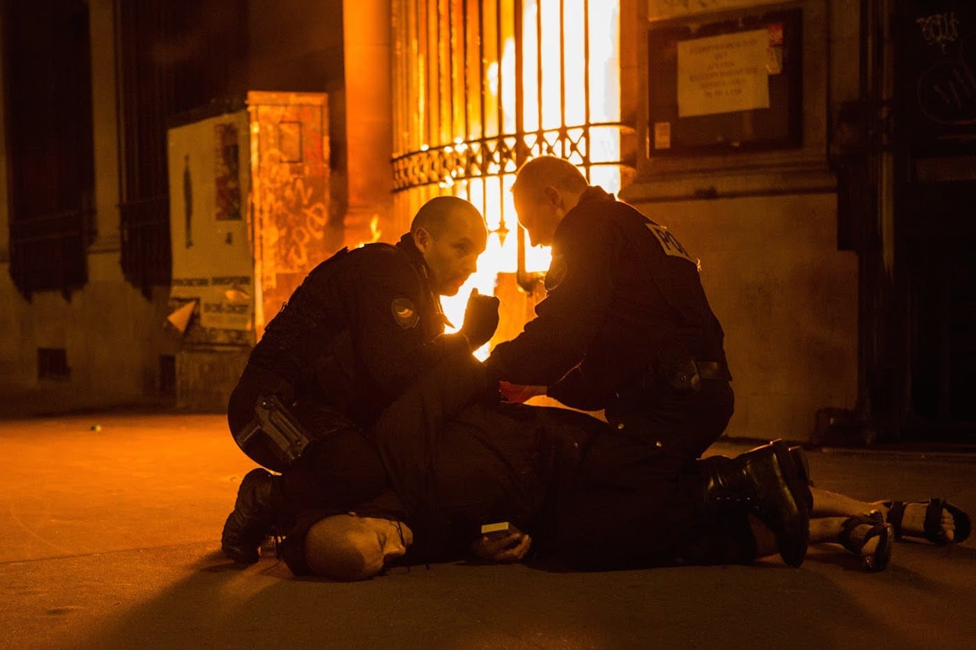 Petr Pavlensky being detained at the scene of his piece, "Lighting," in Paris.