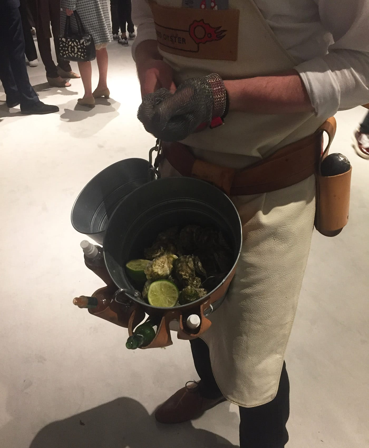 A roving oyster shucker plying the author with a fresh one.