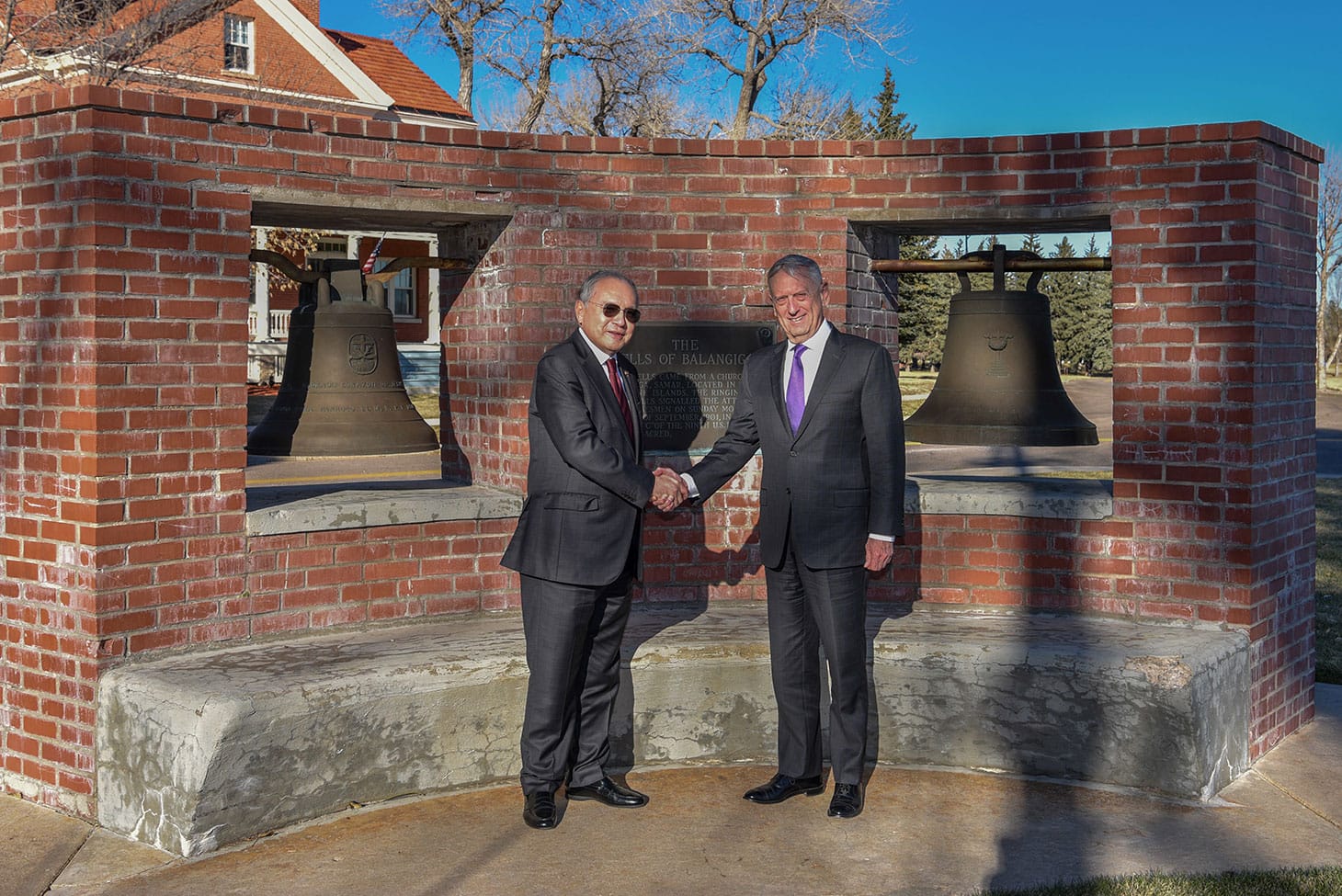 Jose Romualdez, Philippine Ambassador to the United States, and Defense Secretary James N. Mattis, stand for a photo, November 14, 2018, in front of the bells of Balangiga on F.E. Warren Air Force Base, Wyoming (U.S. Air Force photo by Airman 1st Class Braydon Williams, image via F.E. Warren Air Force Base)