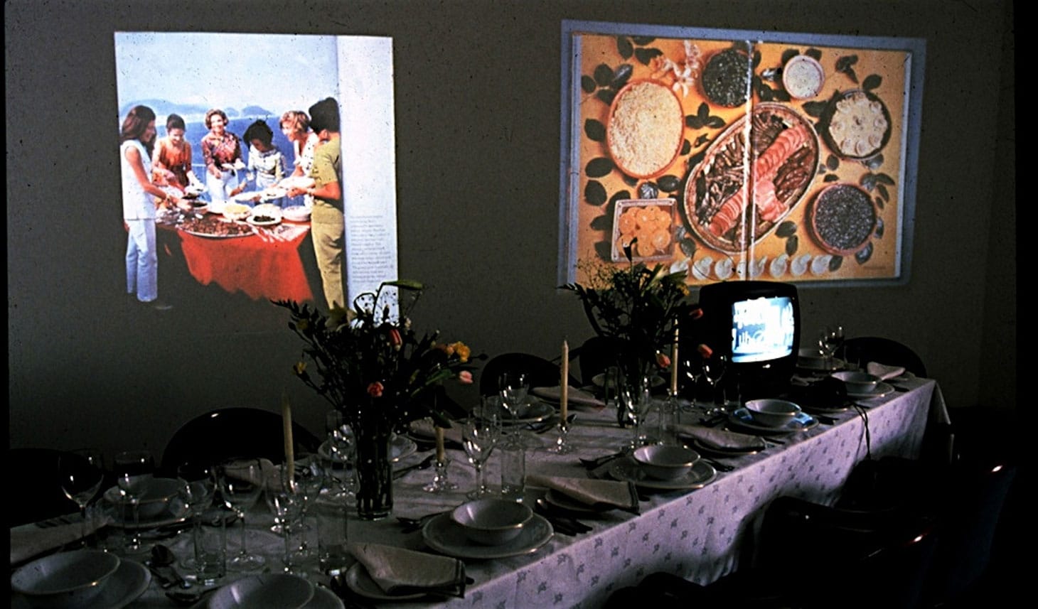 Martha Rosler, "A Gourmet Experience" (1974), installation with banquet table, video, slide projections, audio, books, cookbook readings, and prints of the food novel A Budding gourmet (artwork © Martha Rosler)