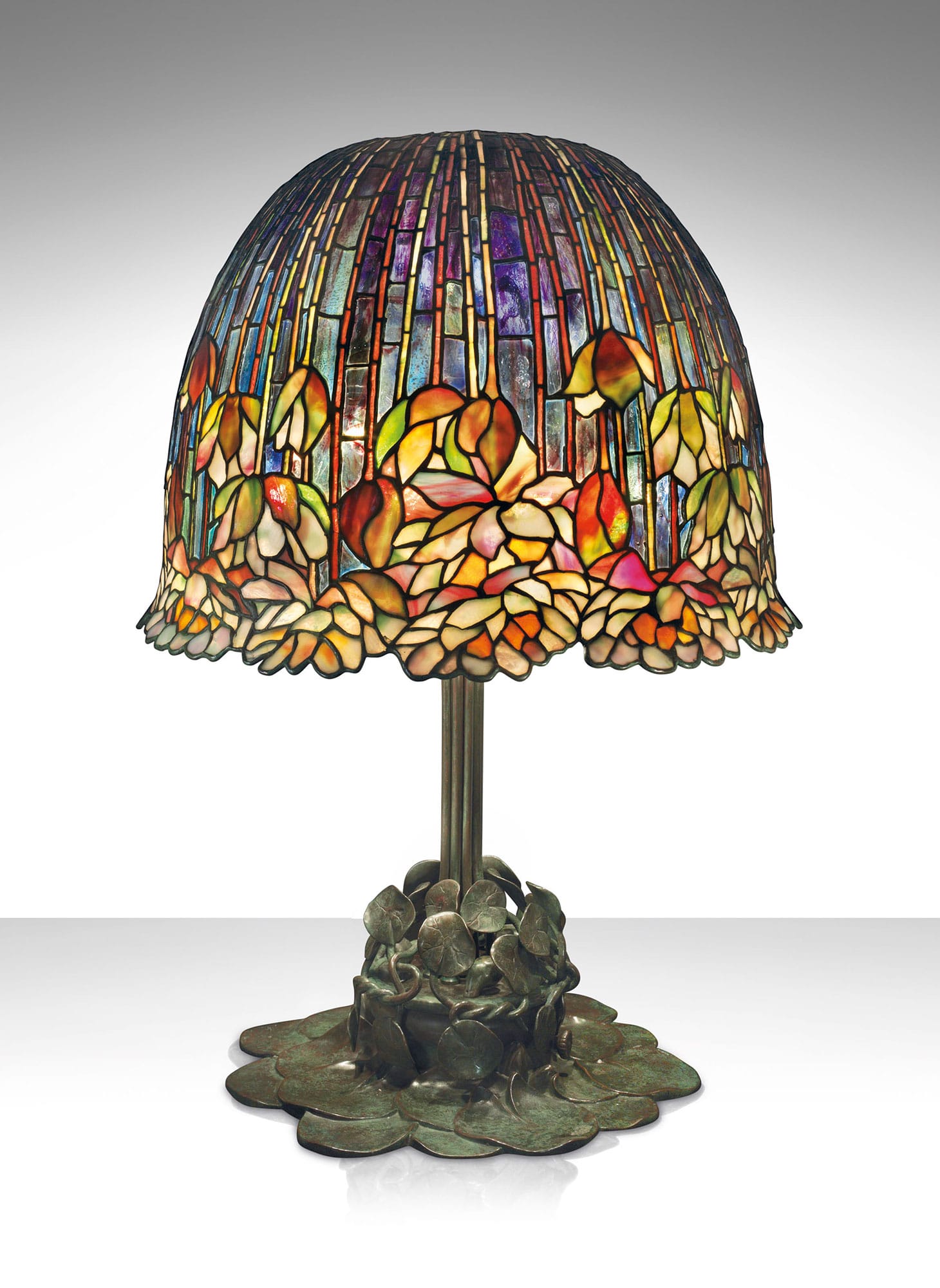 Tiffany Studios, a rare and important "Pond Lily" table lamp (c. 1903), leaded glass, patinated bronze, 26 1/2 inches high, 18 inches diameter of shade (image courtesy Christie's)