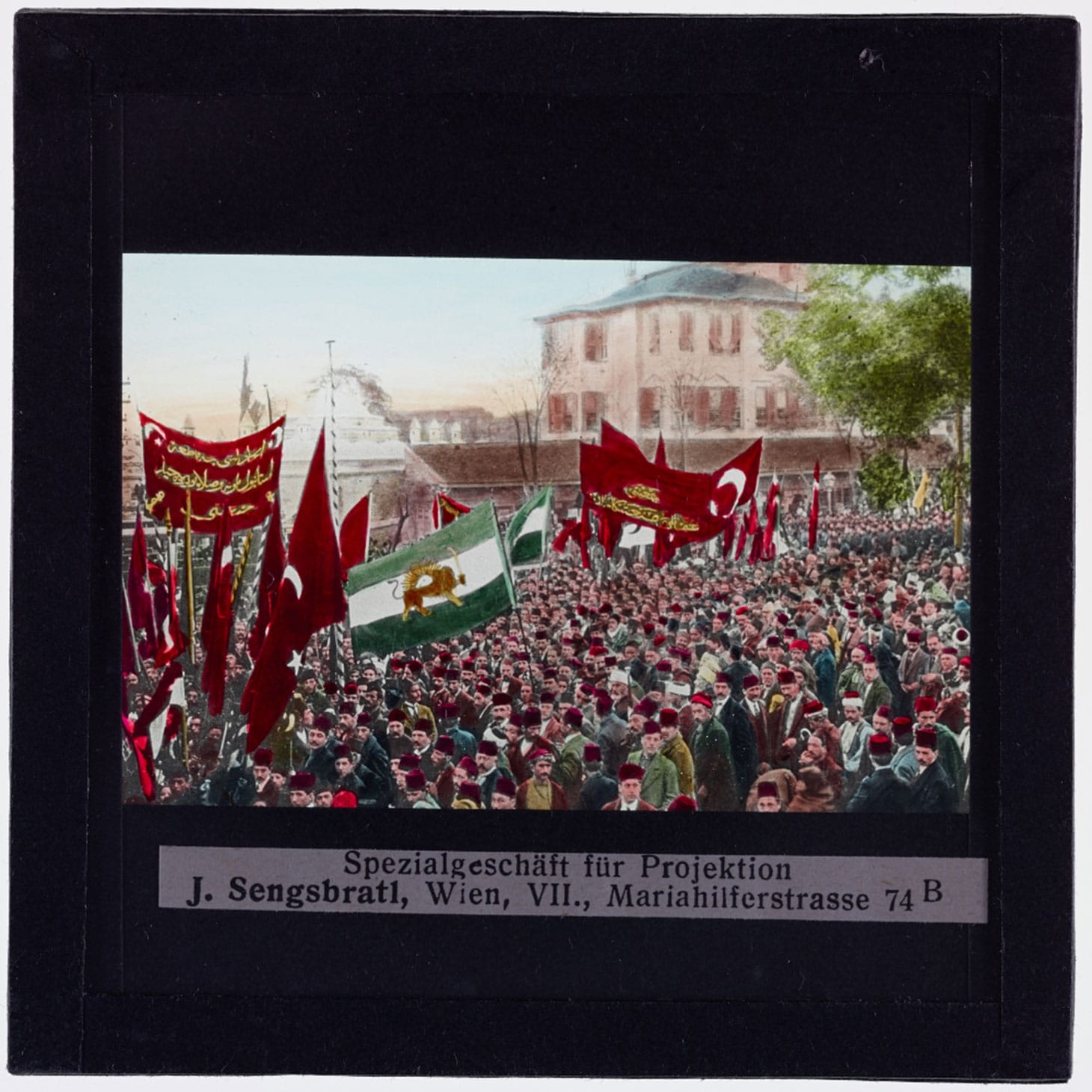 Crowd on the street with Turkish flags, 1900