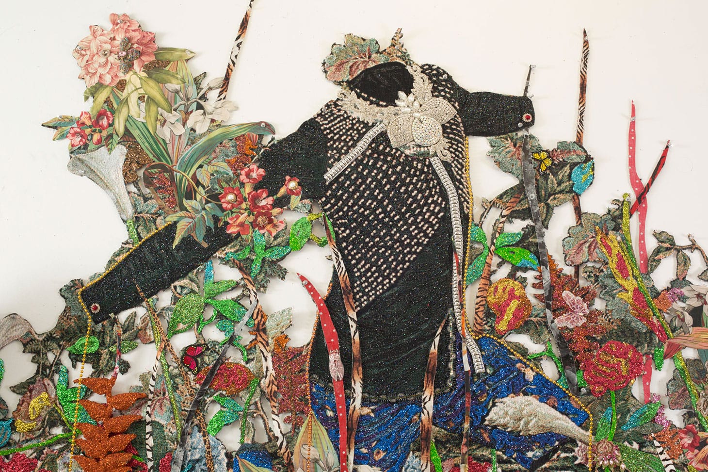 Ebony G. Patterson, "… a wailing black horse … for those who bear/bare witness" (2018), detail, hand cut jacquard photo tapestry with glitter, appliques, pins, embellishments, fabric, tassels, brooches, acrylic, glass pearls, beads, hand cast embellished heliconias, shelf, embellished resin owl, and artist-designed fabric wallpaper (not pictured) (image courtesy the artist and Monique Meloche Gallery, Chicago)