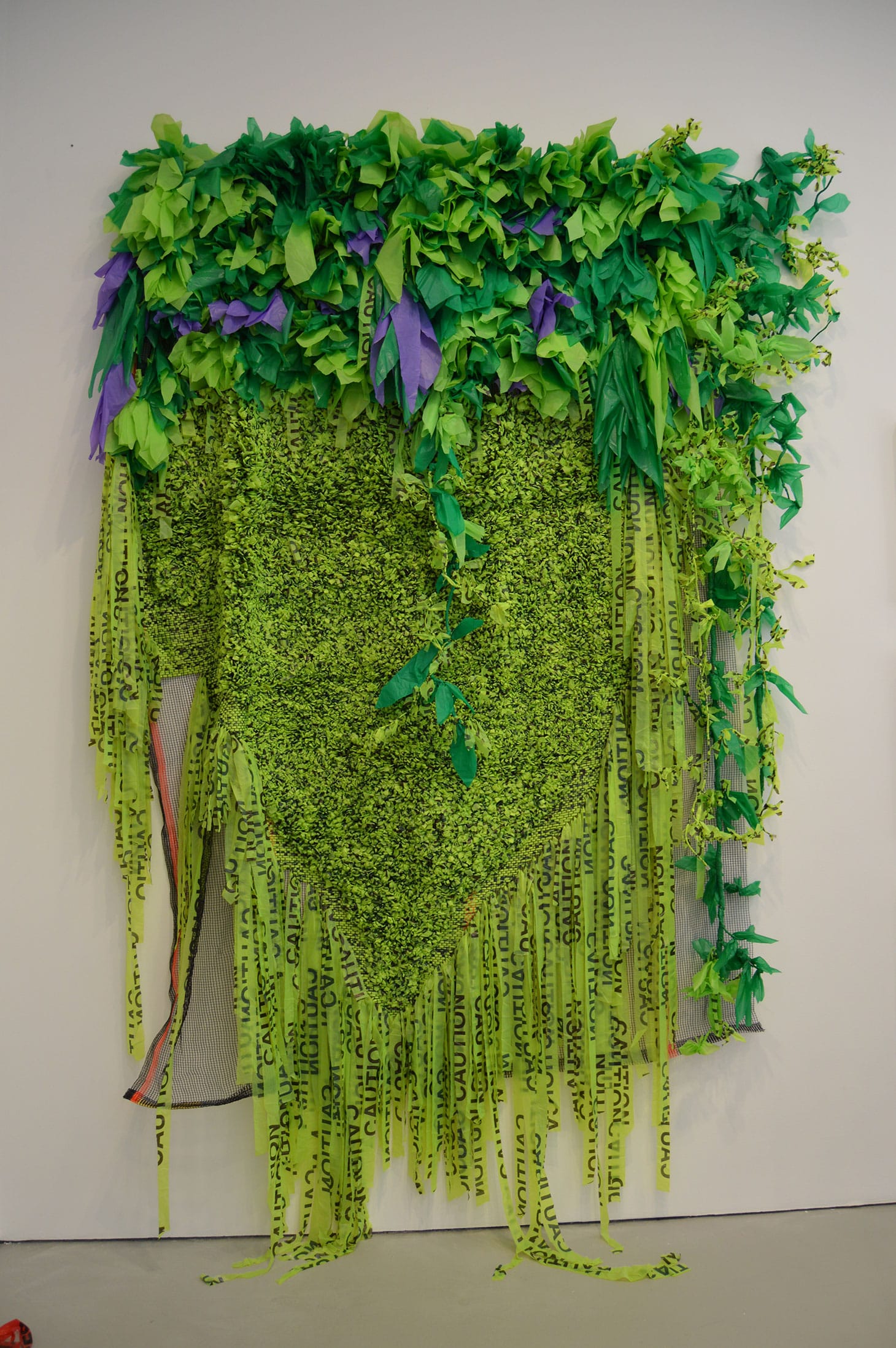 Borinquen Gallo, "Green Unplugged" (2016), caution tape, plastic bags, debris netting, URL cables