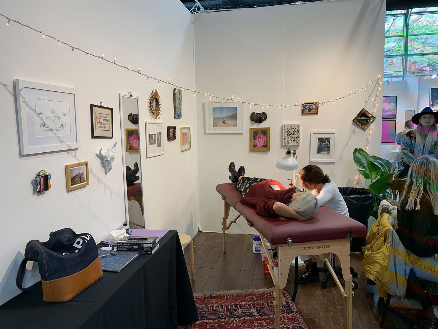 Bluestone Babe tattooing a visitor at The Other Art Fair