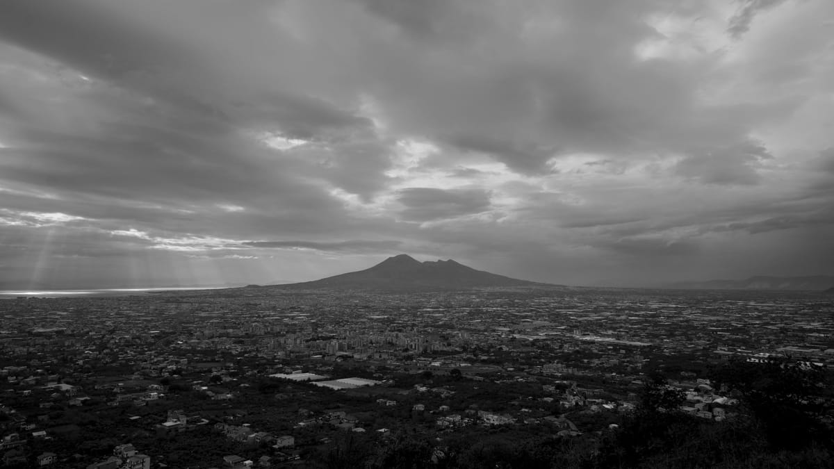 Mount Vesuvius Casts Its Shadow Over Below The Clouds