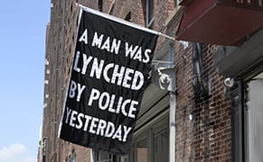 "A Man Was Lynched by Police Yesterday" Flag Goes Up in New York City