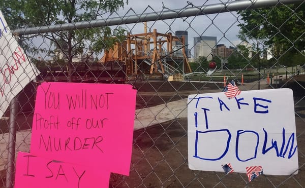 Protest signs on the fence near Sam Durant's "Scaffold" (2012) in the Minneapolis Sculpture Garden