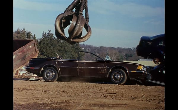 Dispassionate Films of Crushed Cars and the Mirrored Moon