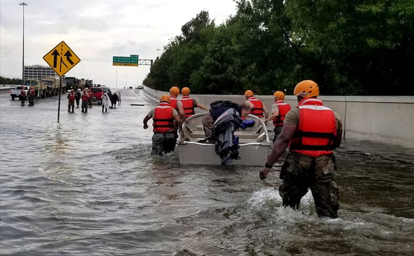 Soldiers with the Texas Army National Guard move through flooded Houston streets as floodwaters from Hurricane Harvey continu