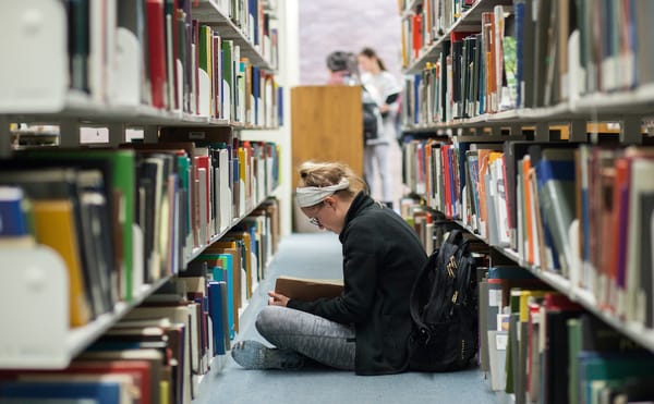 A student in the stacks of the Fine Arts Library at the University of Texas, Austin (courtesy University of Texas Libraries,