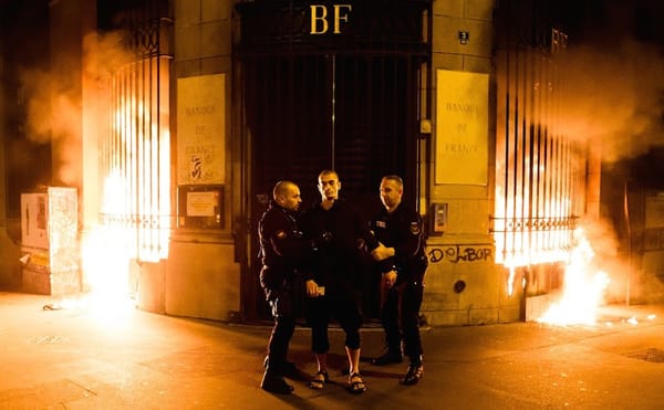 Petr Pavlensky being detained at the scene of his piece, "Lighting," in Paris.