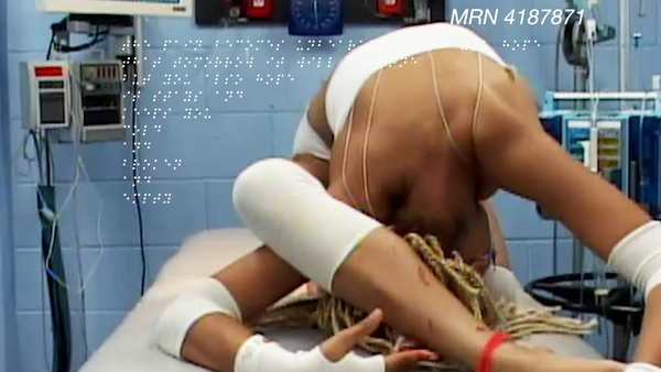 A still image from a 2019 video artwork called "Not Better Yet" by Panteha Abareshi. The photo captures a contortive bodily p