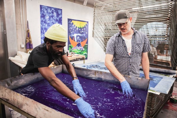 Artist Ivan Forde and Powerhouse Arts Printshop Director Luther Davis creating a print together in the studio.