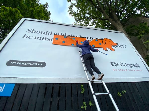 Artist Covers Transphobic Billboard With Giant Dachshund Drawing