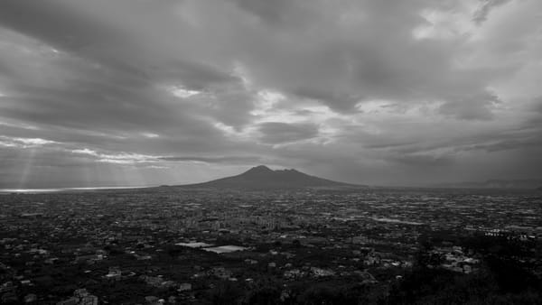 Mount Vesuvius Casts Its Shadow Over Below The Clouds
